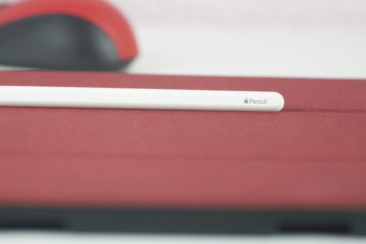 Apple Pencil second generation on top on an iPad pro with Bluetooth Mobile Mouse 3600 by Microsoft in the background